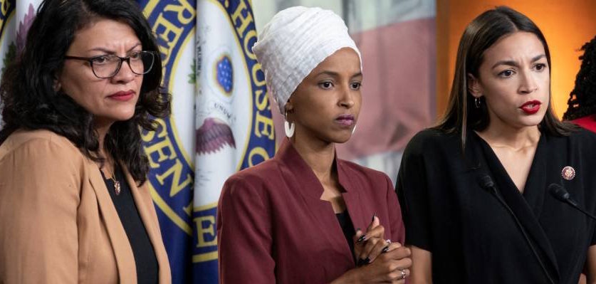 FILE - In this July 15, 2019, file photo, from left, Rep. Rashida Tlaib, D-Mich., Rep. Ilhan Omar, D-Minn., Rep. Alexandria Ocasio-Cortez, D-N.Y., and Rep. Ayanna Pressley, D-Mass., respond to remarks by President Donald Trump after his call for the four Democratic congresswomen to go back to their "broken" countries, during a news conference at the Capitol in Washington. A North Carolina gun shop that drew nationwide attention with a billboard targeting the four minority congresswomen replaced it Monday, Aug. 5, with a sign praising the First Amendment. (AP Photo/J. Scott Applewhite, File)